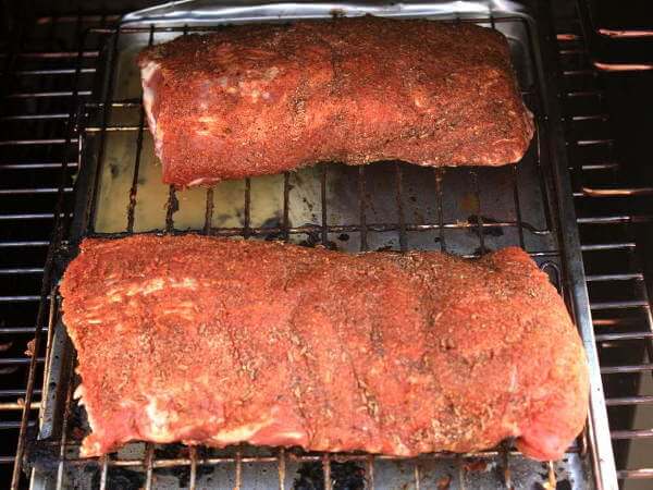 Slab of Babyback Ribs, Separated Into Two Sections, Going Into The Smoker