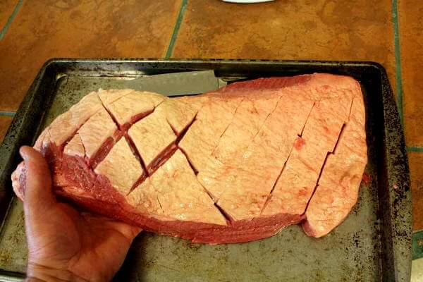 A Whole, Raw Beef Brisket, Showing Scored Cut-Marks In Fat Cap